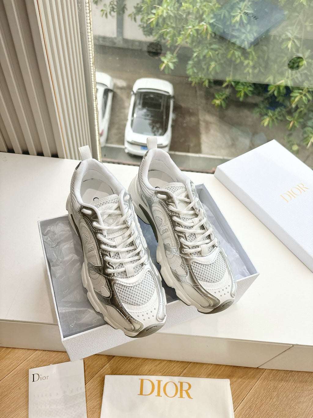 Dior women's sneakers in white with textured panels and lace-up front, side-by-side view