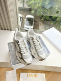 Dior women's sneakers in white with textured panels and lace-up front, side-by-side view
