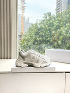 Dior women's white sneakers with textured uppers and lace-up closure, on display