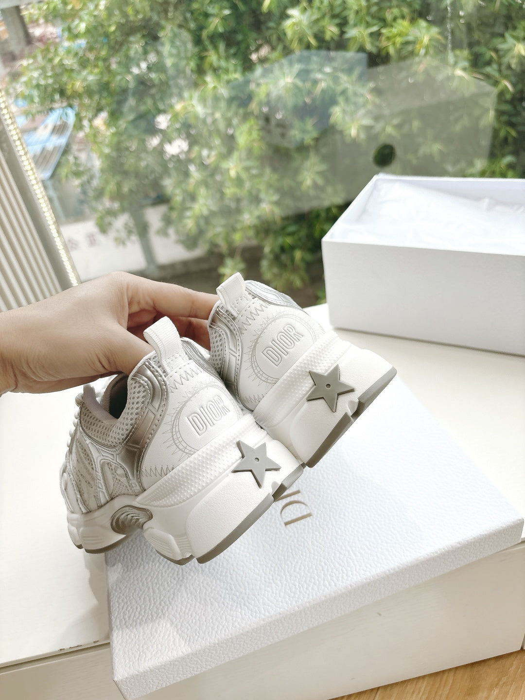 Dior women's white sneakers with star accents on the heel and lace-up closure