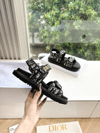 Black Dior sandals with patterned straps and chunky tread sole, side view