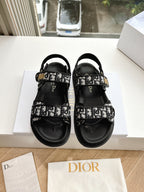 Black Dior sandals with monogram-printed straps and adjustable ankle buckle