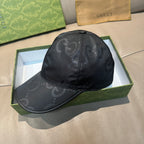 Gucci cap in dark monogram leather-look, side view with curved brim