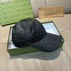 Gucci cap in dark monogram leather-look, front-left angle with curved brim