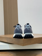 Givenchy sneakers rear view with gray uppers, black heel tabs, and tread sole