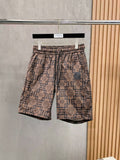 Elastic-waist drawstring shorts with beige and navy geometric Medusa pattern