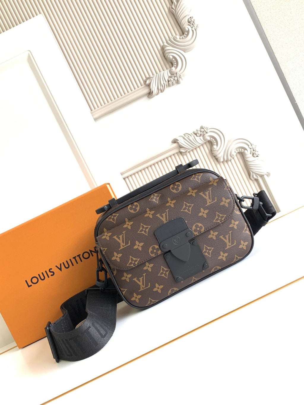 Louis Vuitton monogram crossbody bag with front flap, belt strap, and dark leather trim