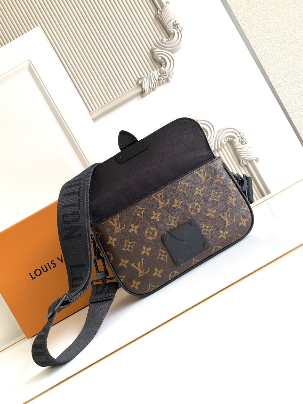 Louis Vuitton monogram crossbody bag with black top flap and adjustable shoulder strap