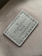 Louis Vuitton fabric label patch reading "Louis Vuitton Paris France" on gray lining