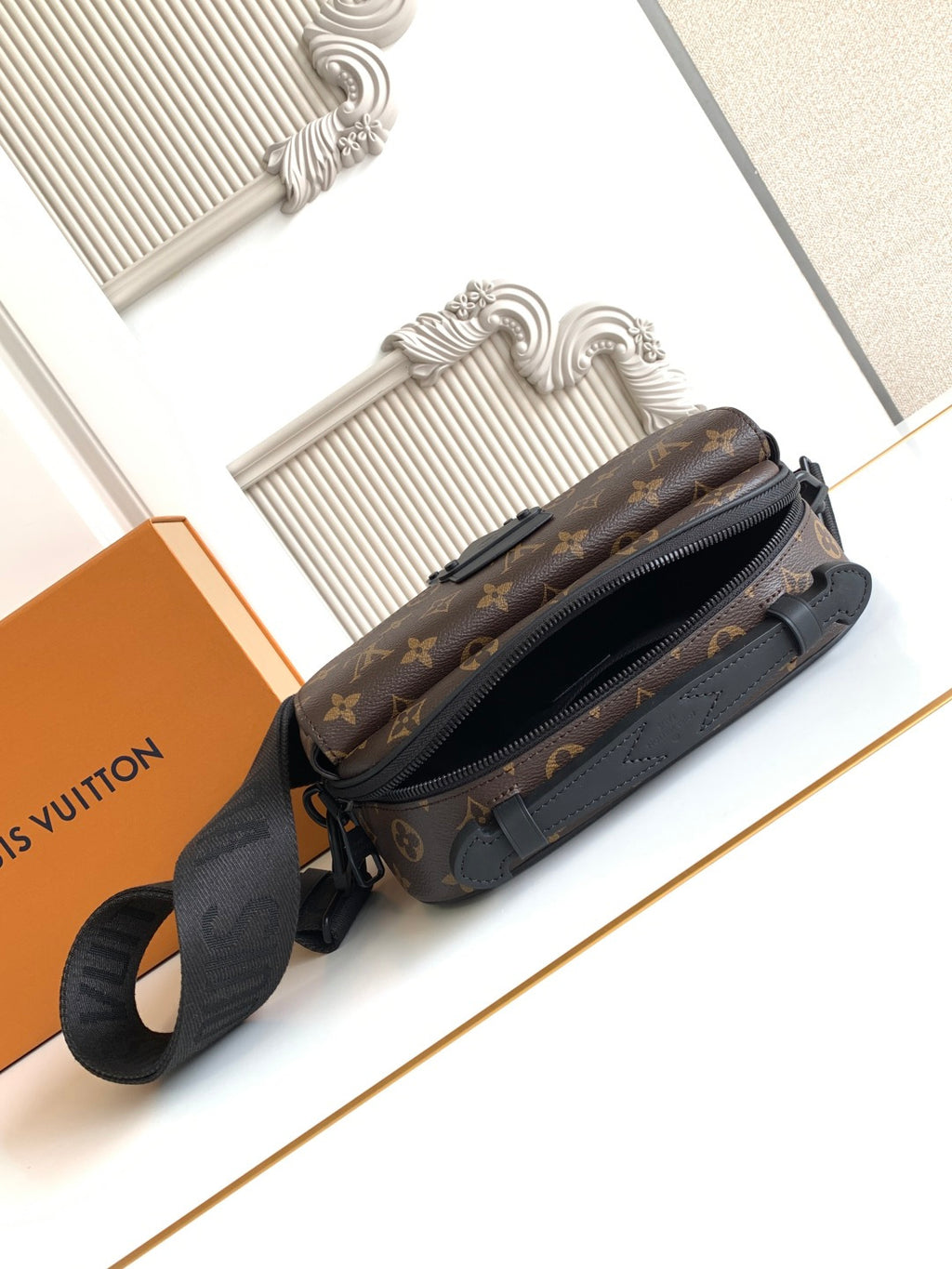 Louis Vuitton monogram crossbody bag with side zipper and adjustable strap, rear angle