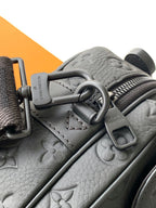 Louis Vuitton monogram crossbody bag closeup in gray with metal rings and strap adjuster