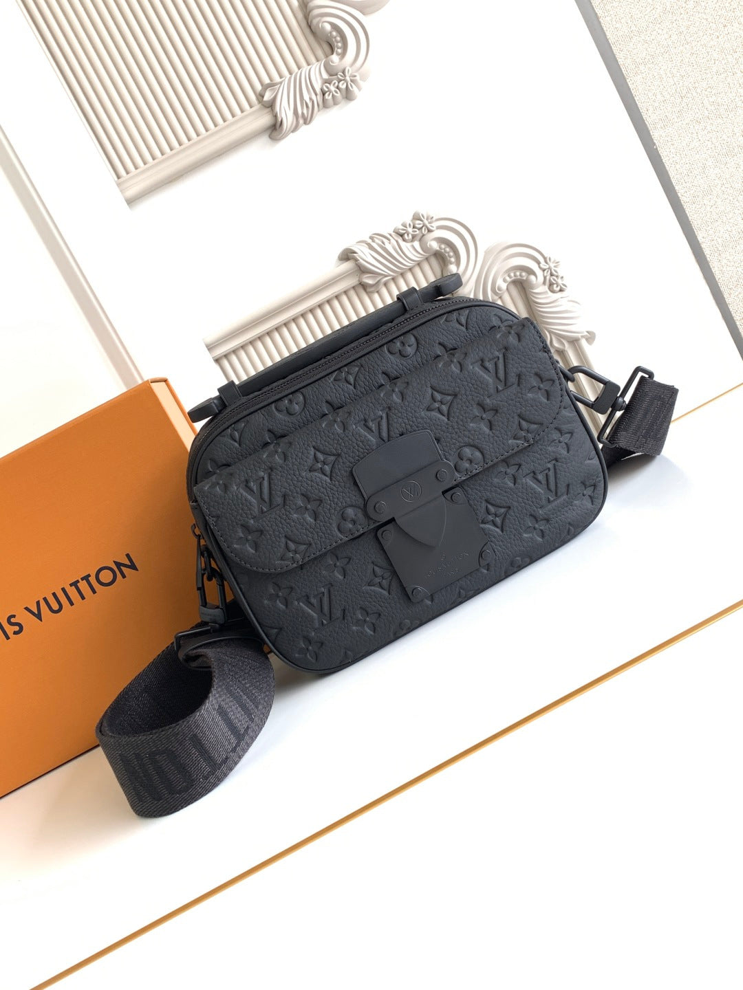 Louis Vuitton monogram crossbody bag in dark tone with adjustable strap and front buckle