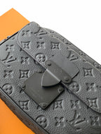 Louis Vuitton monogram bag closeup in gray with snap hardware and embossed logo pattern