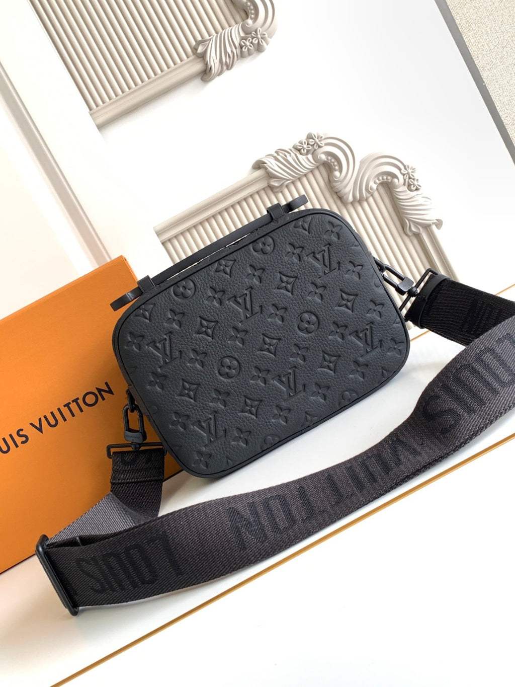 Louis Vuitton monogram crossbody bag in dark tone with adjustable strap and top zipper