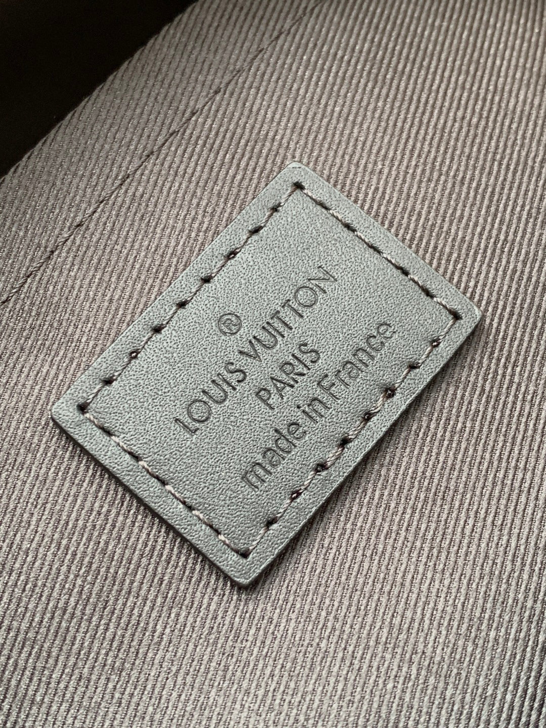 Louis Vuitton interior label patch reading 'Louis Vuitton Paris' and 'made in France'