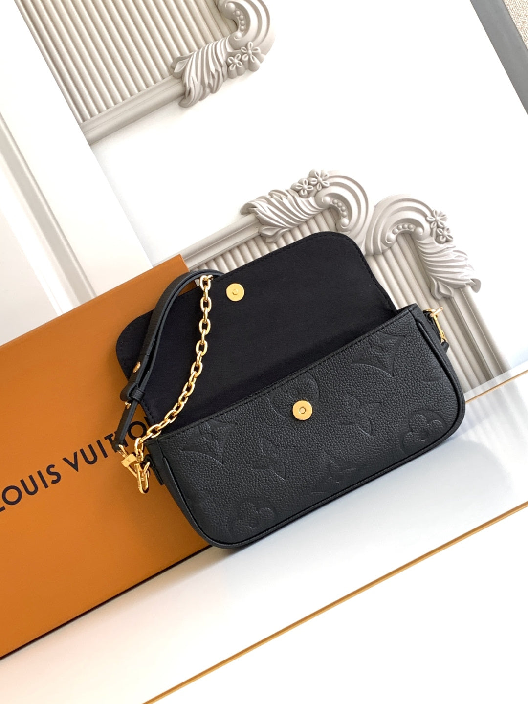 Black embossed leather mini shoulder bag with gold chain strap and snap button