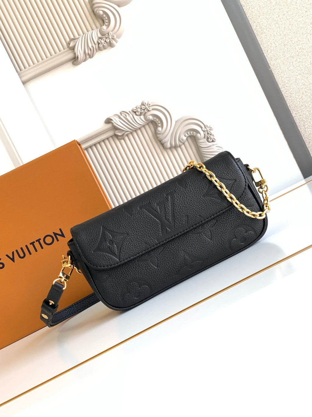 Black embossed leather flap shoulder bag with gold chain strap and front clasp