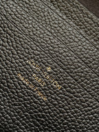 Black pebbled leather with subtle embossed monogram pattern detail