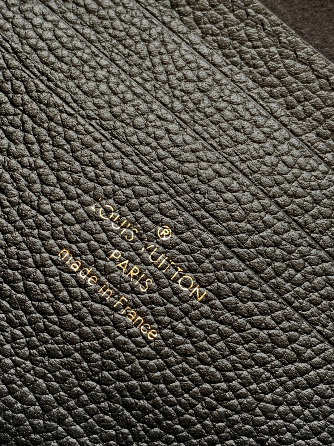 Black pebbled leather with subtle embossed monogram pattern detail