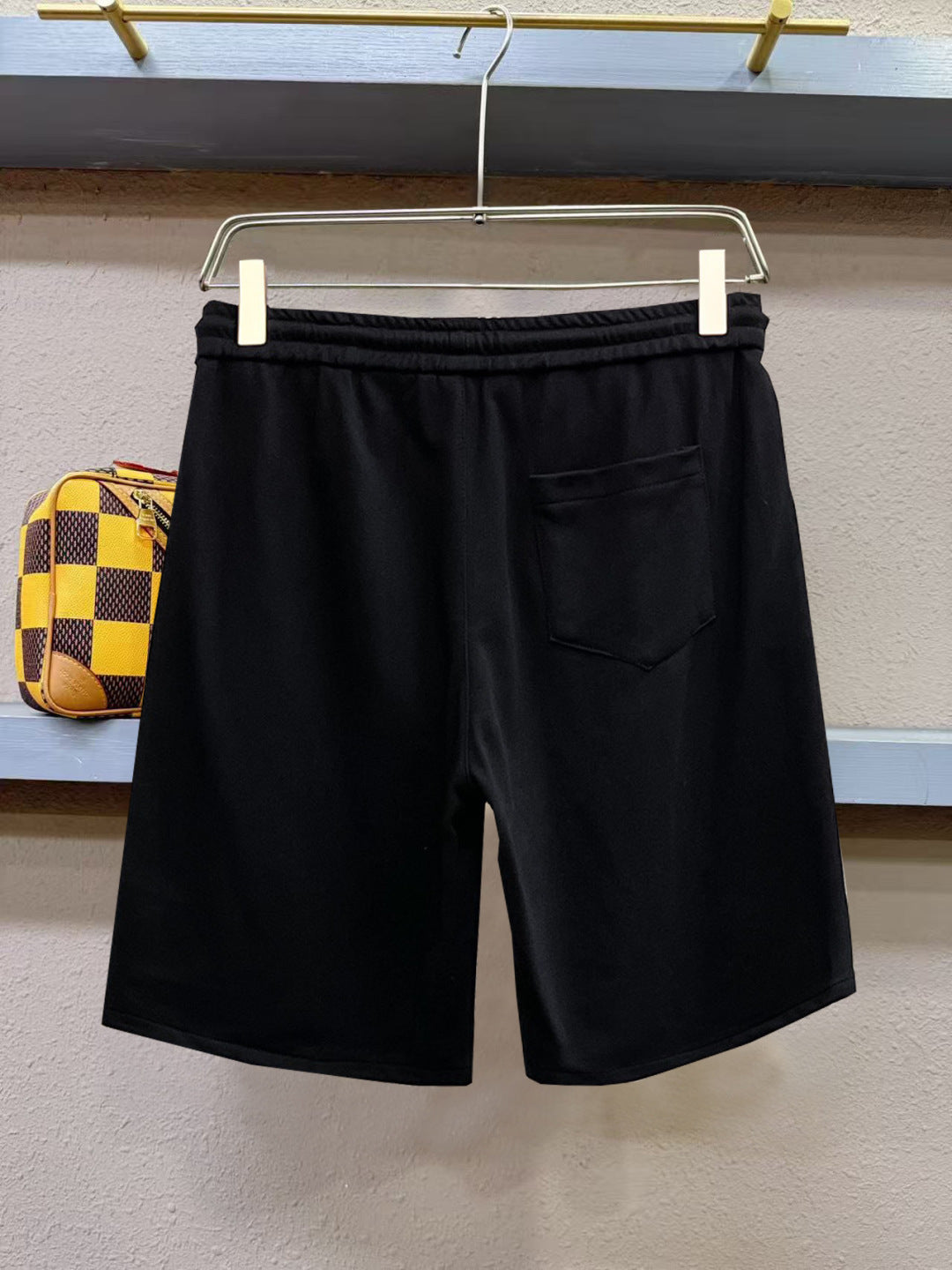 Black shorts with elastic waistband and front pocket detail