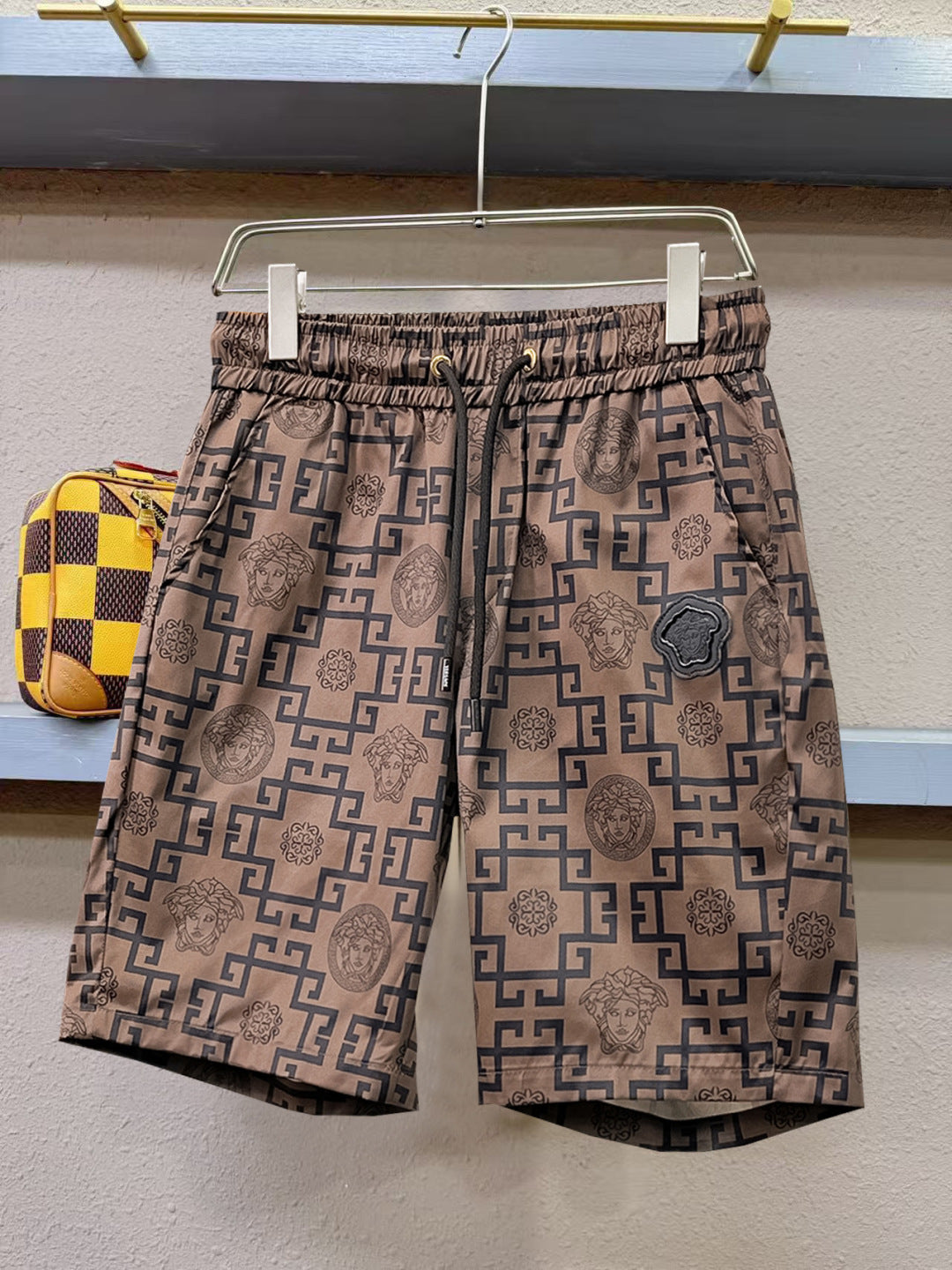 Logo-pattern shorts with elastic waistband and allover geometric Medusa print, tan and navy