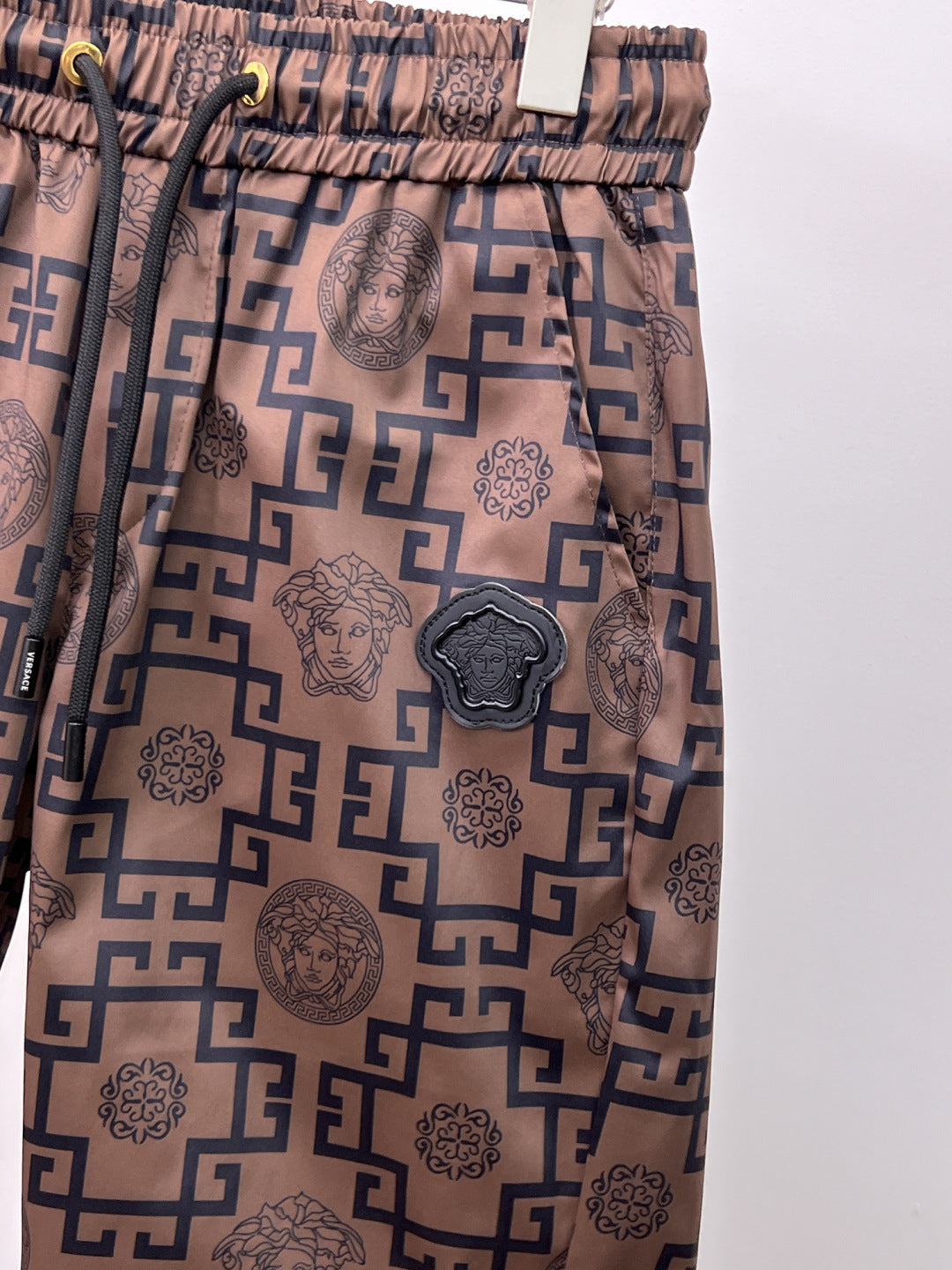 Patterned Versace-style drawstring pants with Greek key and Medusa emblem