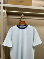 Burberry light blue T-shirt with navy ribbed collar and small chest horse logo.