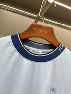 Burberry light blue T-shirt neckline with navy trim and logo-striped collar.