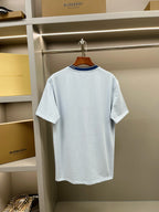 Light blue Burberry crew-neck T-shirt with navy ribbed collar and short sleeves.