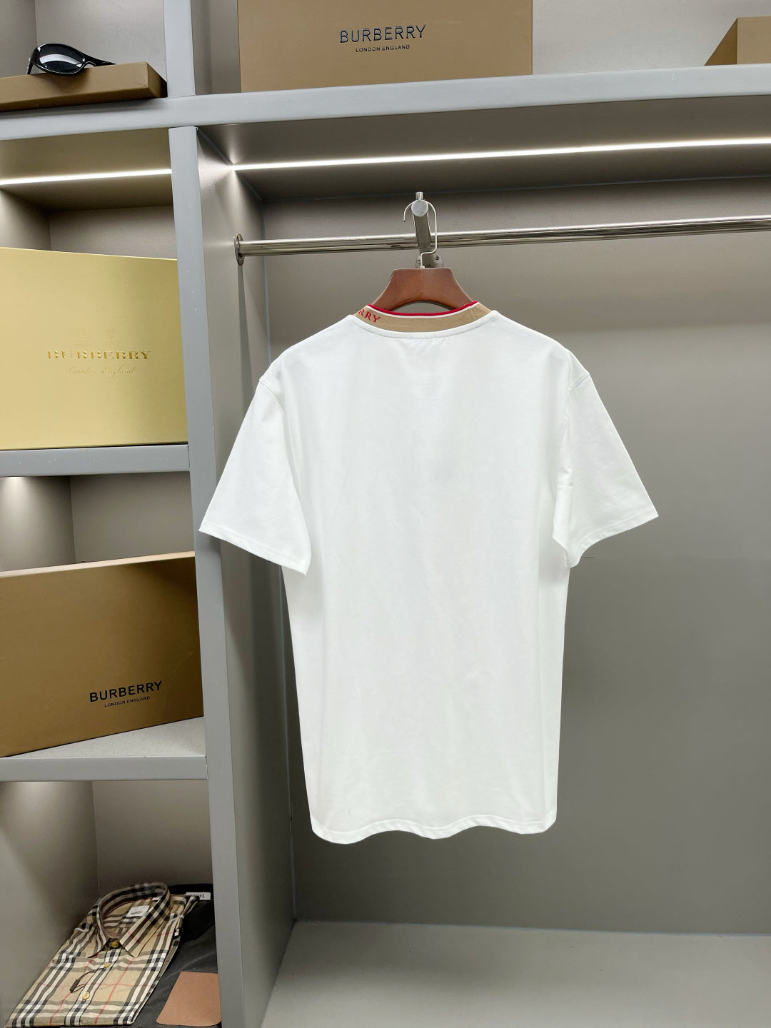White short-sleeve T-shirt with tan crew neck and red trim, full front view.