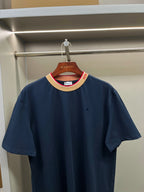 Navy Burberry T-shirt on hanger, crew neck with beige collar and red trim