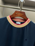 Navy Burberry T-shirt neckline detail with beige ribbed collar and red trim