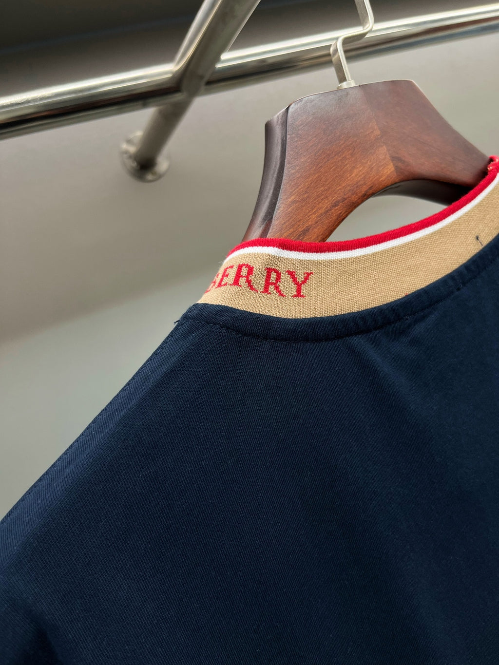 Navy Burberry T-shirt collar detail with beige ribbing and red trim lettering