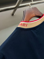 Navy Burberry T-shirt collar detail with beige ribbing and red trim lettering