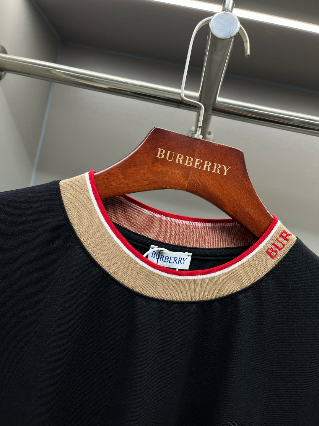 Black Burberry T-shirt collar close-up with ribbed crew neck and multicolor trim.