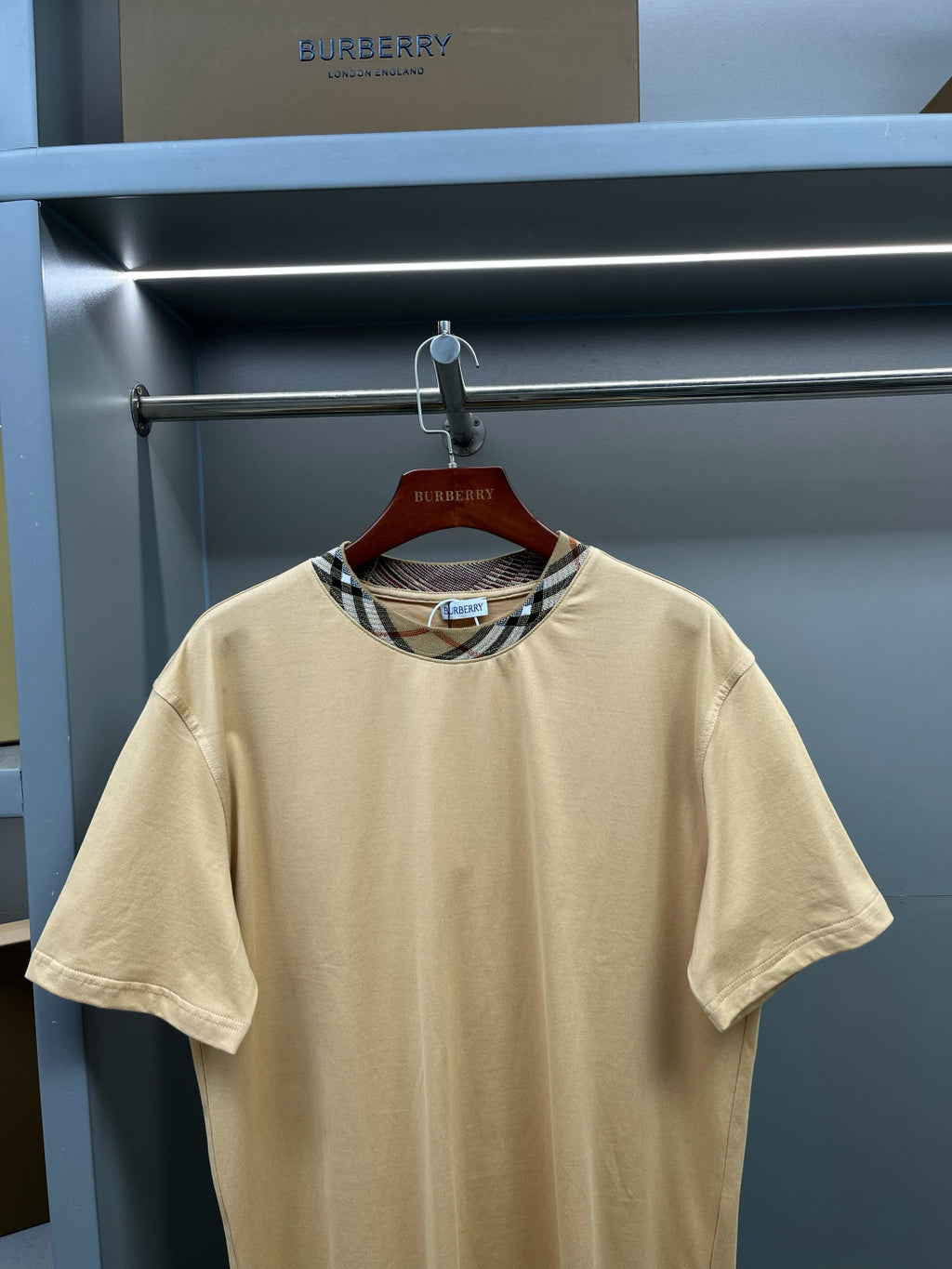 Beige short-sleeve T-shirt with crew neck and multicolor plaid trim at neckline