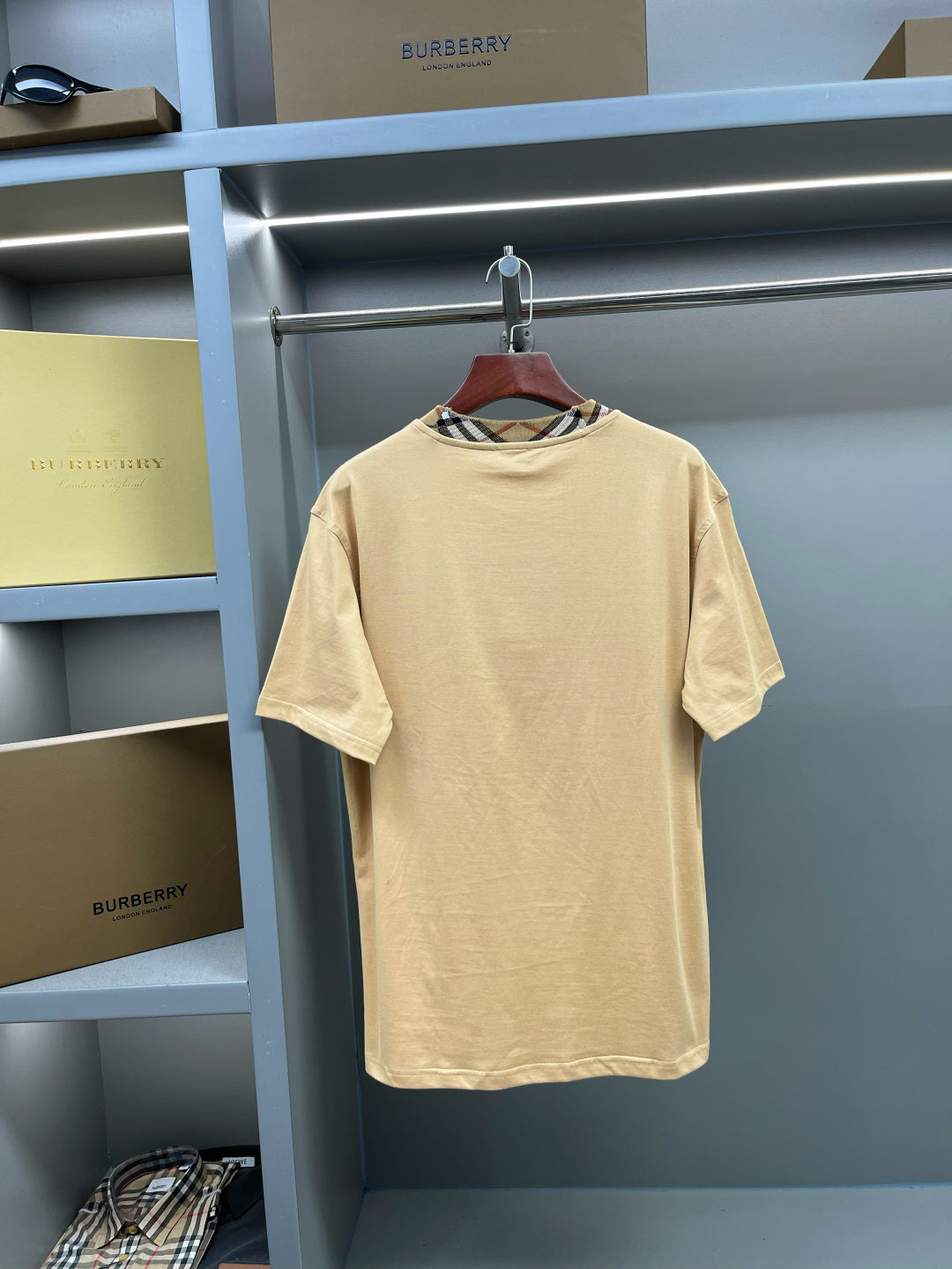 Beige short-sleeve T-shirt on hanger with crew neck and plaid collar trim