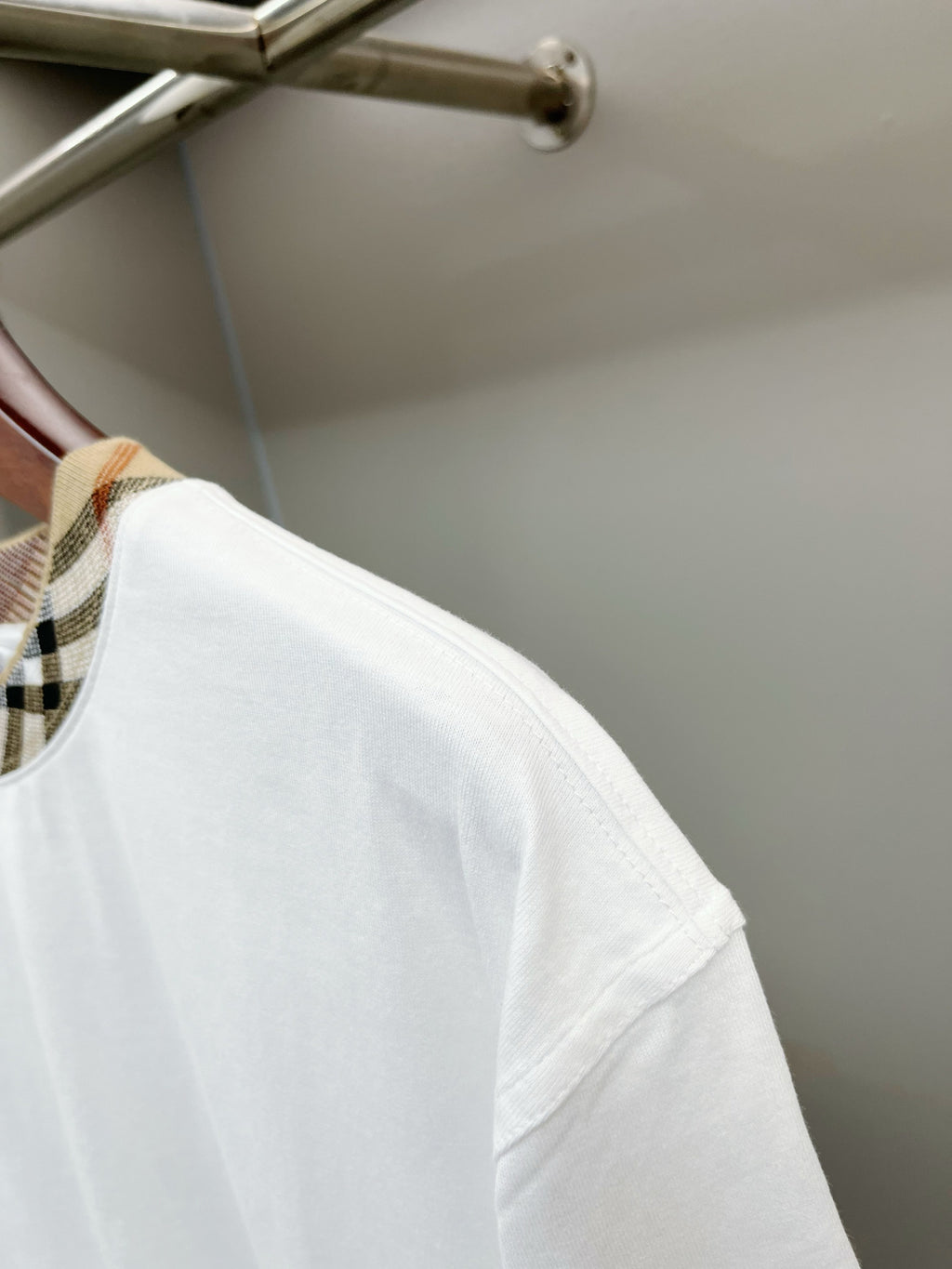 White short-sleeve T-shirt showing side seam and curved hem