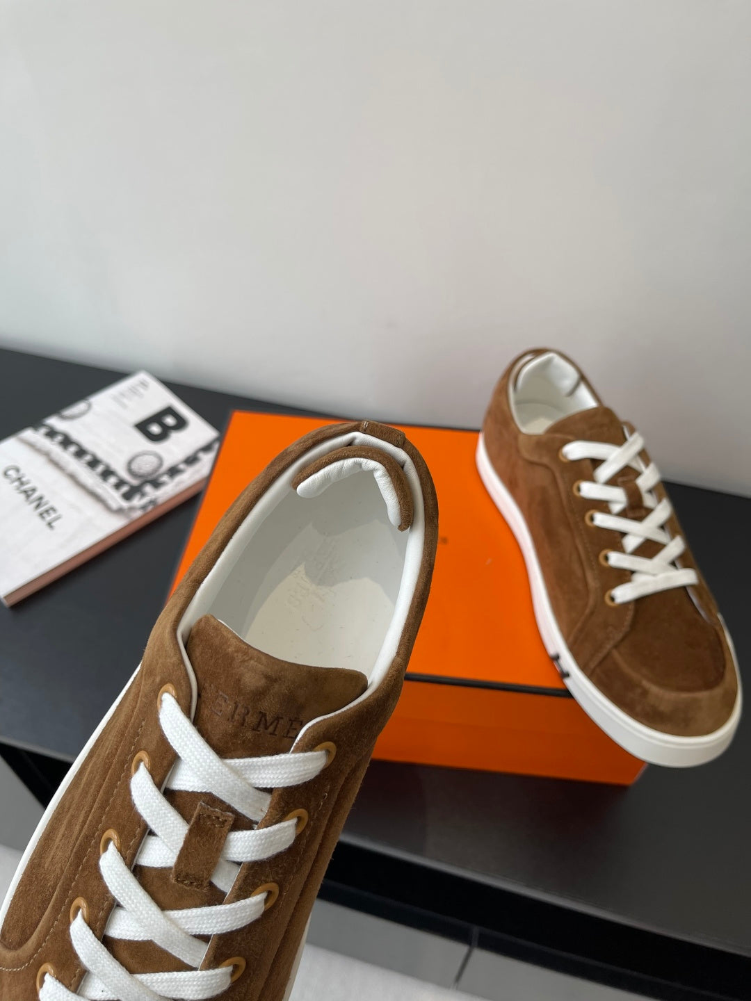 Hermes ladies brown suede sneakers, white lace-up trim and cushioned collar