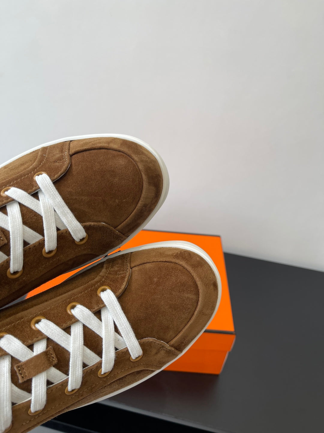 Hermes ladies brown suede sneaker toe, white laces and low-profile sole