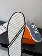 Rubber outsole of blue suede sneakers with textured tread