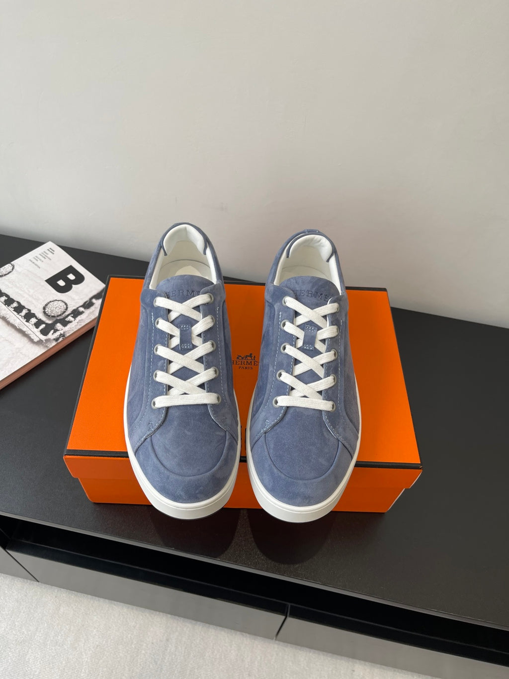 Blue suede lace-up sneakers with white eyelets and rubber sole