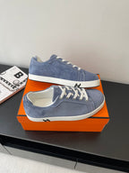 Blue suede lace-up sneakers with white soles and lace-up closure