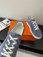 Blue suede sneakers with white laces and light interior lining