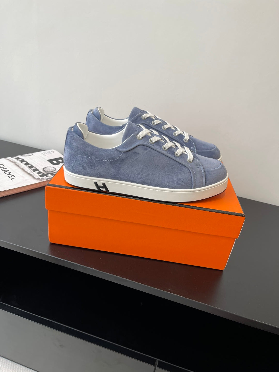 Blue suede low-top lace-up sneakers with white laces and trim