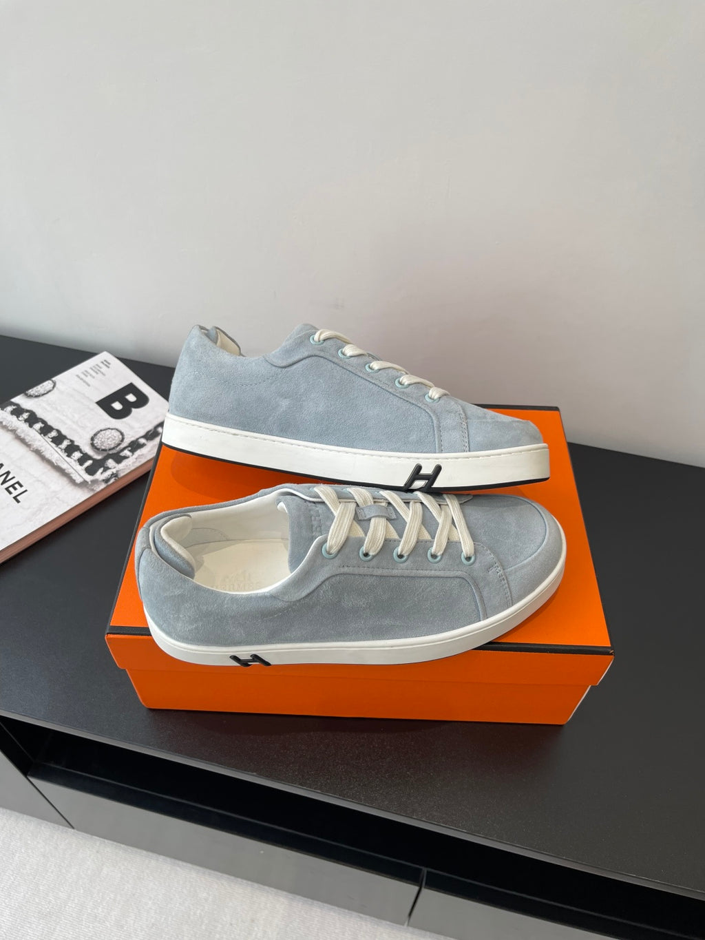Hermes light blue suede sneakers with white laces and striped rubber sole trim