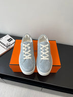 Hermes light blue suede lace-up sneakers with white laces and rubber sole