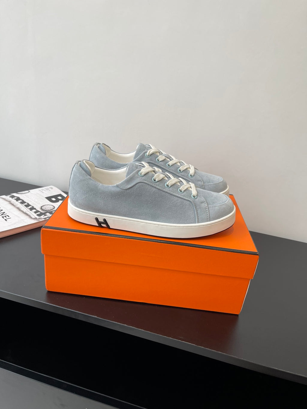 Hermes light blue low-top sneakers with white lace-up closure and side panel