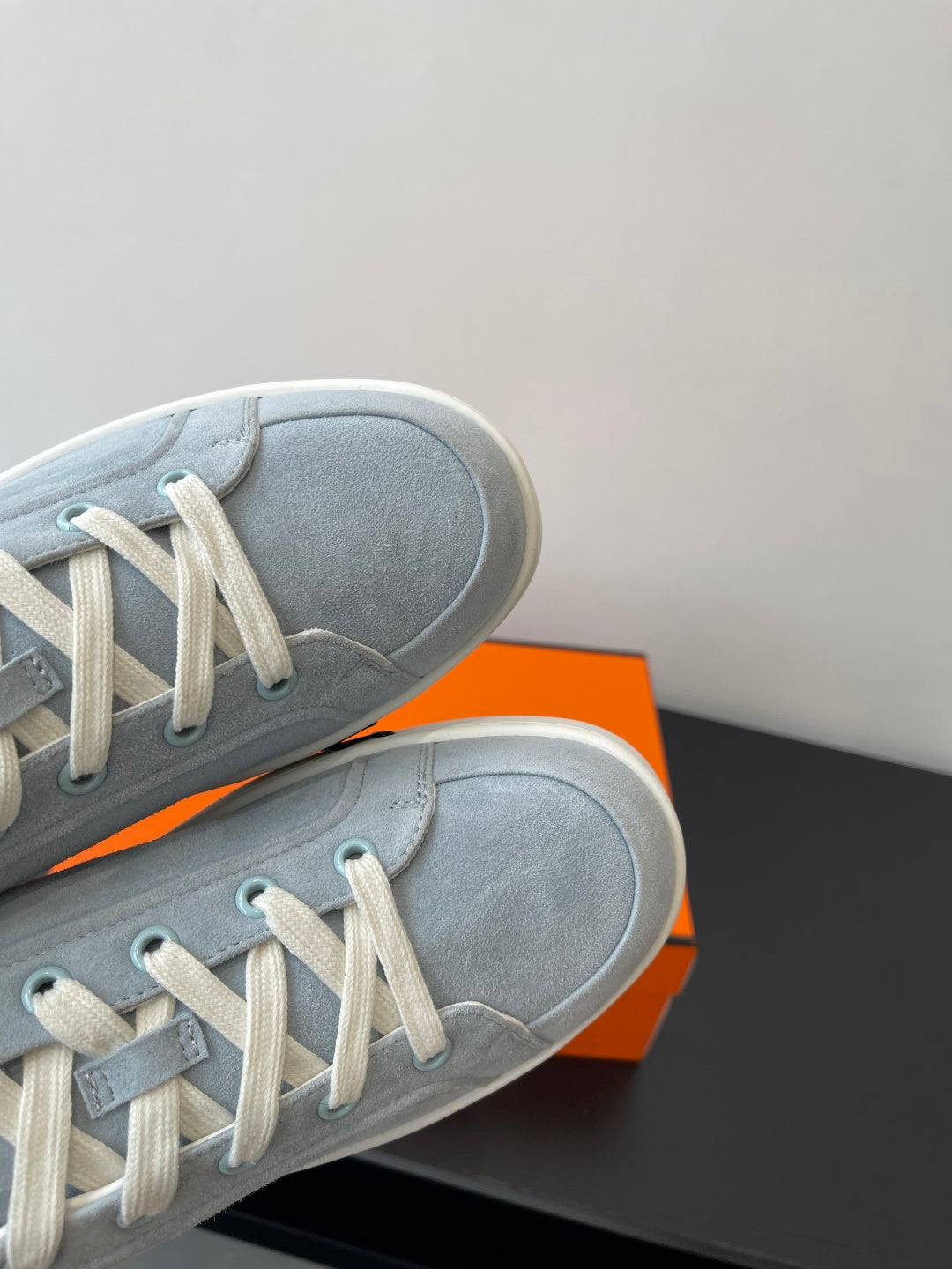 Hermes light blue suede sneakers with white laces and white rubber trim