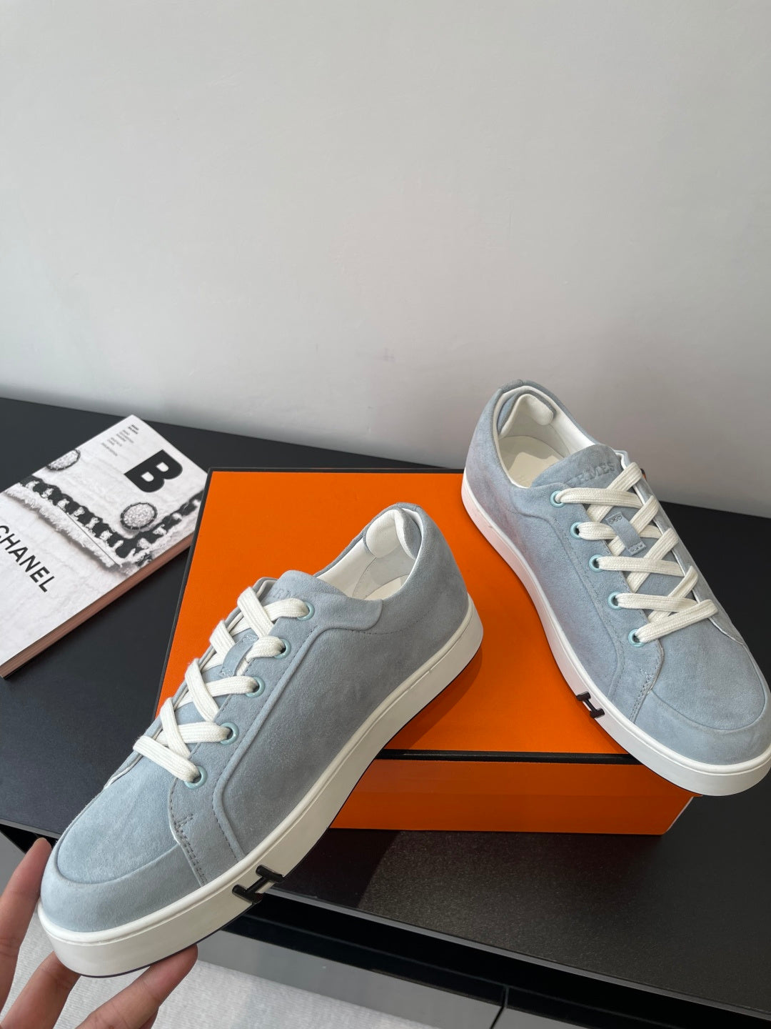 Hermes light blue suede sneakers, lace-up front view with rubber toe cap